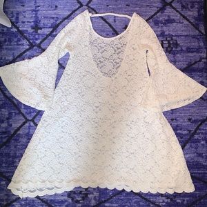 White lace dress with low back and bell sleeves